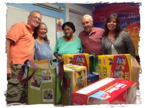 SAC Board members JP Bissy, Angelita Santiago, Richard Letart and Yanneth Bermudiez-Camp present food and household products donated to Neddy Latimer, Director!