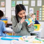 Young girl working with LEGO S.T.E.A.M. educational toy.